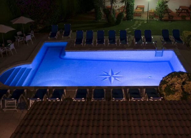 A high angle shot of a pool full of warm water  in the garden
